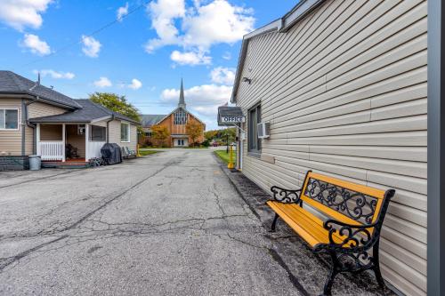 a bench sitting on the side of a building at Nights Inn Owen Sound in Owen Sound