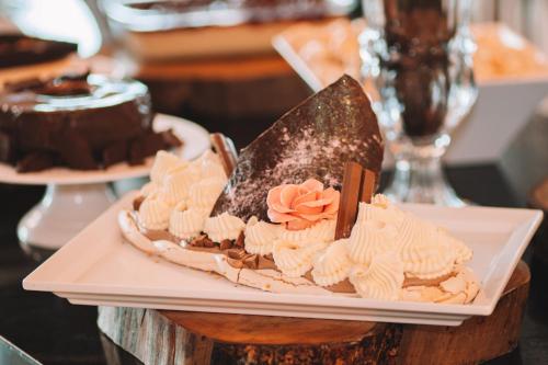 a plate of desserts on a table with a cake at Itá Thermas Resort e Spa in Itá