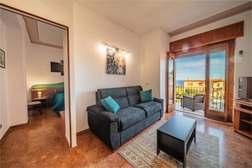 a living room with a couch and a bedroom at SUITE APARTMENT TAORMINA in Taormina