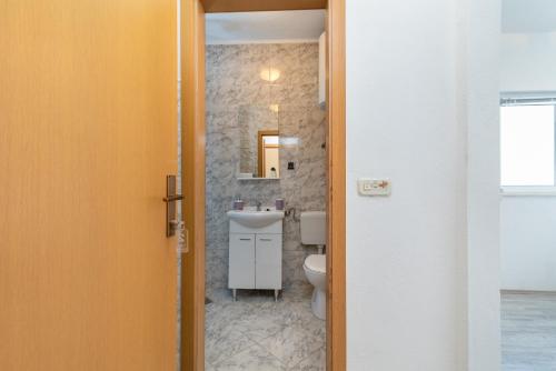 a bathroom with a sink and a toilet at Aldino Rooms in Trogir