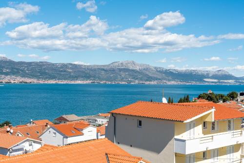 a view of a town with orange roofs and the ocean at Aldino Rooms in Trogir
