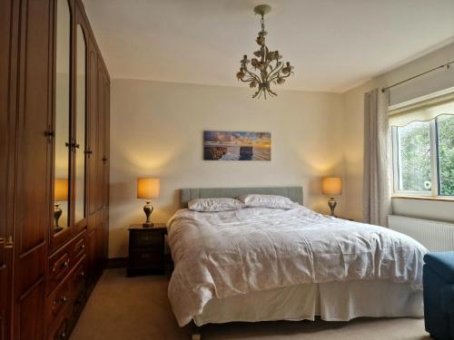 a bedroom with a bed and a chandelier at Carraig Ban in Cong