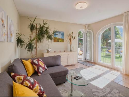 a living room with a couch and a glass table at Casa Alla Roccabella in Minusio