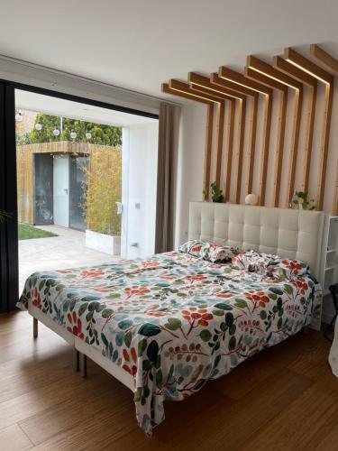 1 dormitorio con 1 cama con colcha de flores en Passivhaus con jardín en La Rioja, en Entrena