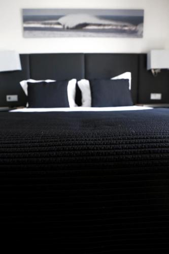 Ένα ή περισσότερα κρεβάτια σε δωμάτιο στο Hotel M