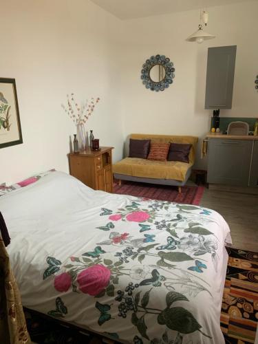 a bedroom with a bed with a flowered blanket at Norfolk broads. Vault apartment in Stalham