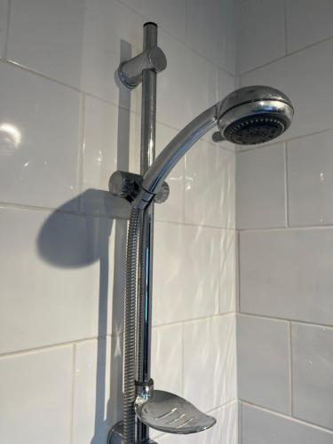 a shower in a bathroom with a shower head at COSY 3 - City View in Sunderland