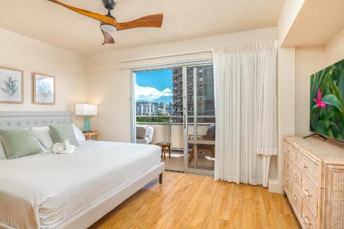 a bedroom with a bed and a large window at Welcome to Your Slice of Paradise at Ilikai Hotel in Honolulu