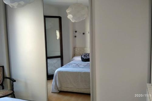 a bedroom with a bed and a mirror at CASA RO in Tarragona