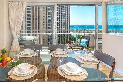 a dining room with a table with a view of the ocean at Welcome to Your Slice of Paradise at Ilikai Hotel in Honolulu