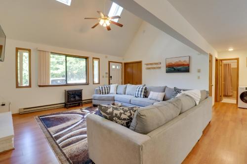 a living room with a couch and a ceiling fan at Poconos Cabin Serene Deck, Fire Pit and Game Room in Tobyhanna