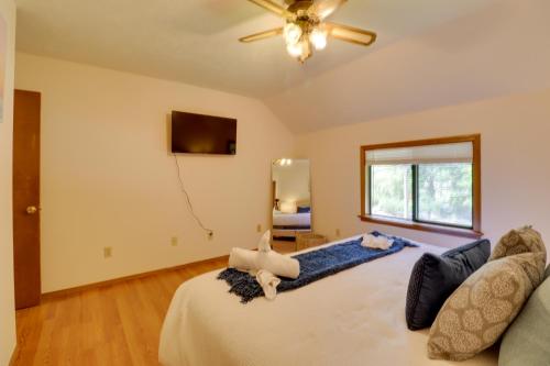 a bedroom with a bed and a ceiling fan at Poconos Cabin Serene Deck, Fire Pit and Game Room in Tobyhanna