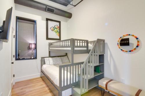 a small room with a bunk bed and a staircase at Trendy Galveston Getaway - Walk to Downtown! in Galveston