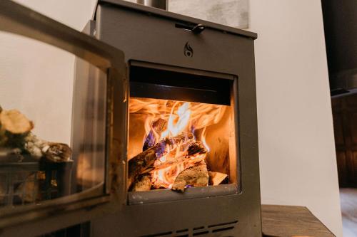 a stove with a fire inside of it at Vistas del Conde in Heredia