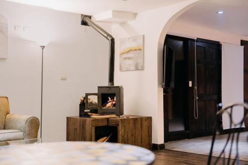a living room with a wood stove in front of a door at Vistas del Conde in Heredia