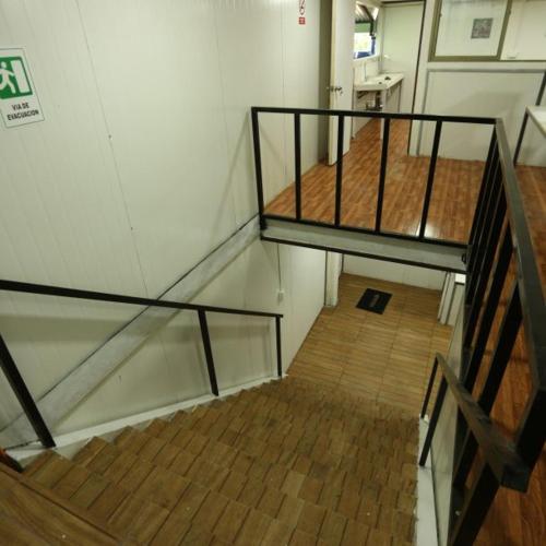 klatka schodowa w pokoju z drewnianą podłogą w obiekcie hostal ibiza w mieście Talca