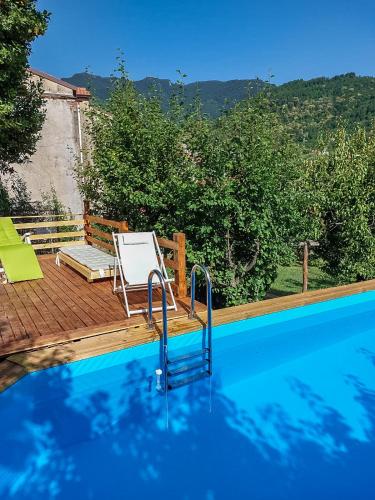 a swimming pool with a chair and a table at Artesia - Junior Suite in Angellara