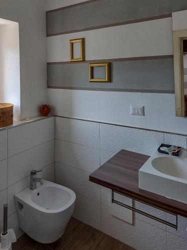 a white bathroom with a sink and a toilet at Artesia - Junior Suite in Angellara