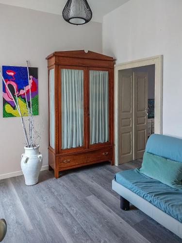 a living room with a couch and a cabinet at Artesia - Junior Suite in Angellara