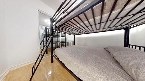 a bedroom with a bunk bed with a metal bed frame at The Blue Water House in San Juan