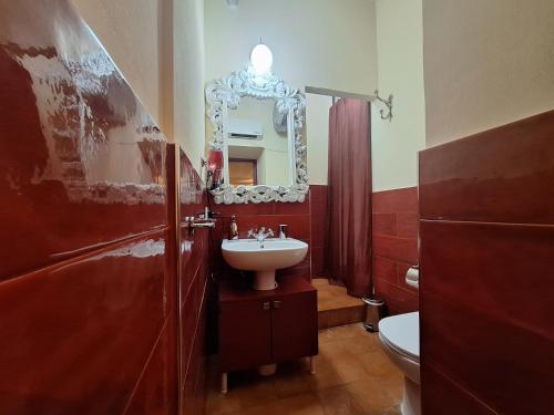 a bathroom with a sink and a mirror at Passione Romana Apartment in Rome