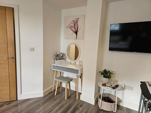 a bathroom with a dressing table and a mirror at ZenZone Studio Flat in Preston