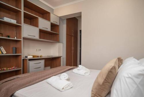 a bedroom with a bed with towels on it at La Vie Villa in Zakynthos Town