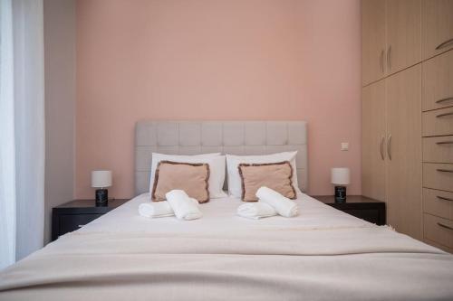 a bedroom with a large bed with two pillows at La Vie Villa in Zakynthos Town