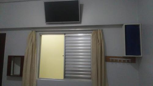 a room with a window with a television on the wall at Hotel Endless Love in Carapicuíba