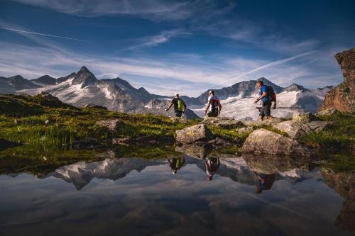 a group of three people standing on top of a mountain at HEAVEN 7 SUITE - Garden Apartment with Private Whirlpool in Zillertal, presented by AlpenLuxus in Fügen