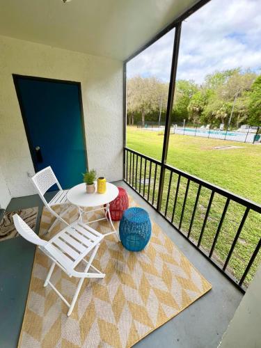 a patio with a table and chairs on a balcony at Oasis 105 - Blue Bliss in Titusville