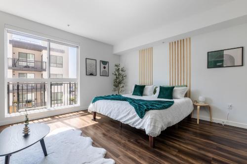 a bedroom with a bed and a large window at Luxury Home in Hollywood with Pool I Gym I Free Parking in Los Angeles