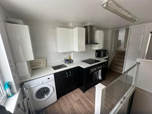 a small kitchen with a washing machine and a washer at 120 Mortimer St, Herne Bay in Kent