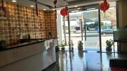 a restaurant lobby with potted plants on the counter at The Patioz Boutique Hotel in Kajang