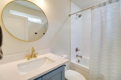 a white bathroom with a sink and a mirror at Waterfront Retreat on Greers Ferry Lake with Hot Tub in Heber Springs