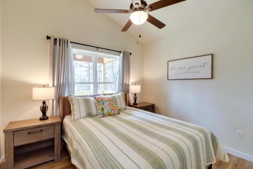 a bedroom with a bed and a ceiling fan at Waterfront Retreat on Greers Ferry Lake with Hot Tub in Heber Springs