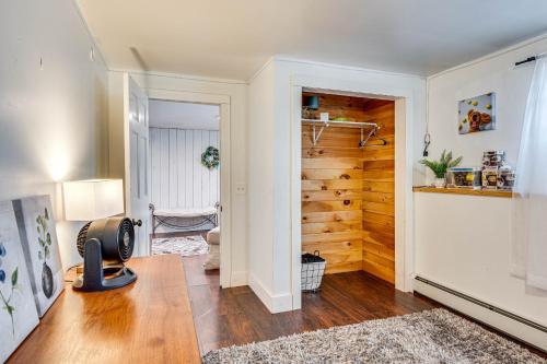 a living room with a hallway with a wooden wall at Over Andover Retreat with Hot Tub Walk to Lake! in Andover