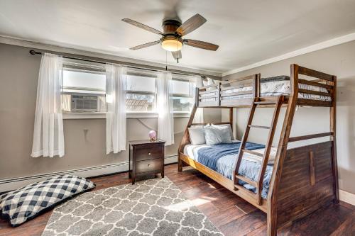 a bedroom with bunk beds and a ceiling fan at Over Andover Retreat with Hot Tub Walk to Lake! in Andover