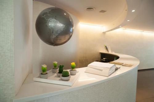 una habitación con un mostrador blanco con un globo en la pared en FerroHotel, en Módica
