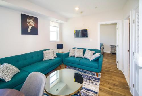 a living room with a green couch and a table at The Chey:Modern and Intimate in Washington, D.C.