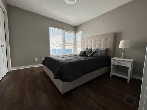 a bedroom with a large bed and a window at Luxury Downtown Townhome Unit 14 in Cleveland