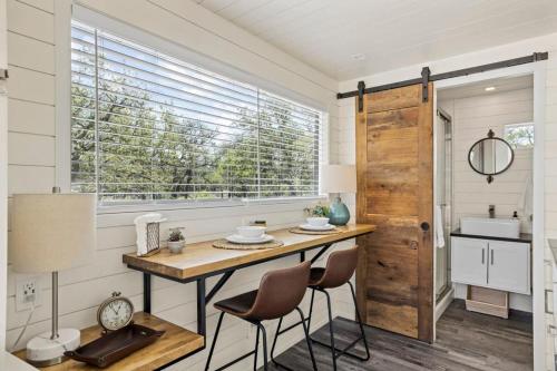 a kitchen with a table and two chairs and a window at New! Luxury Shipping Container The Desert Escape in Fredericksburg
