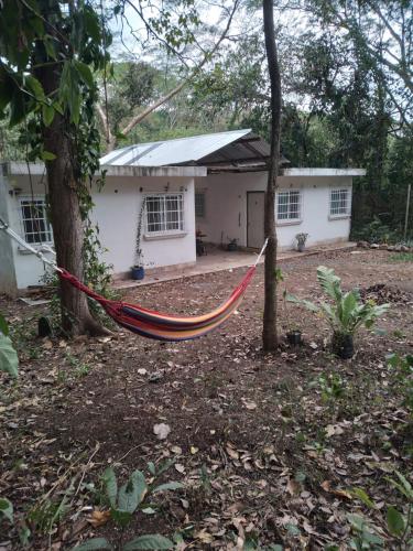 a hammock in front of a house at CASA RIO in Escuintla
