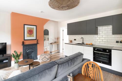 a living room with a couch and a kitchen at London Street in Bath