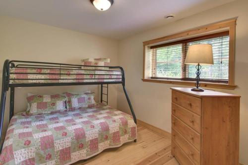 a bedroom with a bunk bed and a dresser at Le Cerf #40 in Mille-Isles