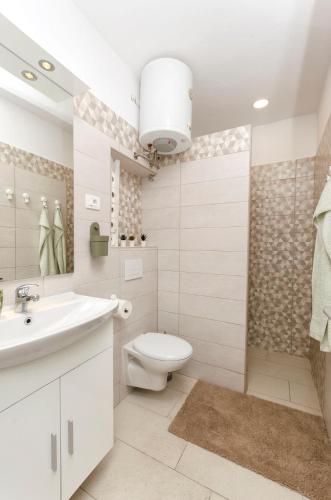 a bathroom with a toilet and a sink and a shower at House Violica in Vodice