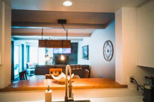 a kitchen and a living room with a table at Beautiful Condo 3-Eleven at Tremblant in Mont-Tremblant