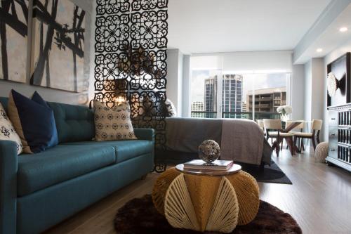 a living room with a blue couch and a table at Deluxe Studio in Coconut Grove City and Bay views Includes Parking in Miami