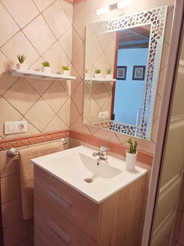 a bathroom with a sink and a mirror at Ca l'Èndula II in Lucena del Cid