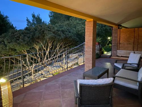 a porch with chairs and a balcony with a view at Wild sud Sardinia 3 in Teulada